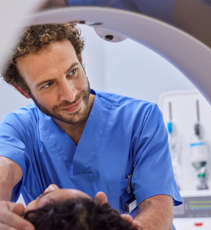 Radiographer preparing patient for scan