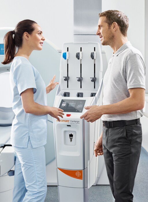 Healthcare workers talking about MEDRAD<sup>®</sup>  Centargo