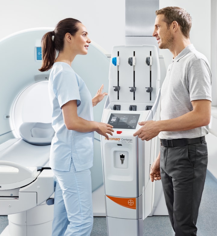 Healthcare workers talking about MEDRAD<sup>®</sup>  Centargo